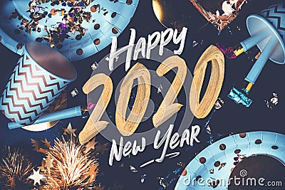 2020 happy new year hand brush storke font on marble table with party cup,party blower,tinsel,confetti.Fun Celebrate holiday party Stock Photo