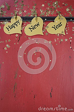 Happy New Year haning hearts on red distressed wood Stock Photo