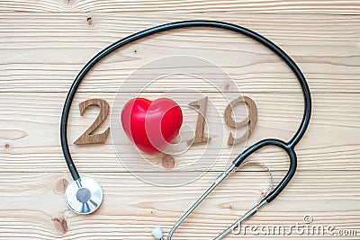 2019 Happy New Year for healthcare, Wellness and medical concept. Stethoscope with red heart and wooden number on table Stock Photo