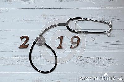 2019 Happy New Year for healthcare, Wellness and medical concept. Stethoscope with wooden number on table Stock Photo