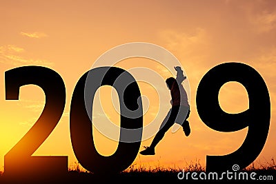 Happy new year jumping from 2019 silhouette. Stock Photo