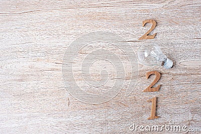 2021 Happy New year with lightbulb and wooden number on table. New Start, Idea, Creative, Innovation, Resolution, Solution, Stock Photo