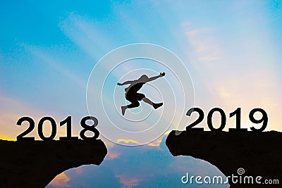 Happy New Year 2019 Men jump over silhouette mountains Stock Photo