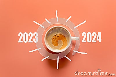 Happy new year and Merry Christmas 2024. Cup of coffee change and download 2023 to 2024 on orange background. Stock Photo