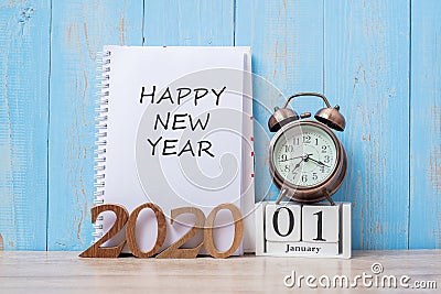 2020 Happy New Year with notebook, retro alarm clock and wooden number. New Start, Resolution, Goals, Plan, Action and Mission Stock Photo