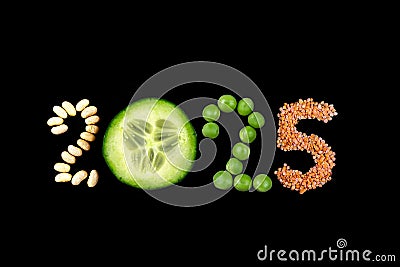 Happy New Year 2025 number made of cucomber and dry vegetable on black Stock Photo