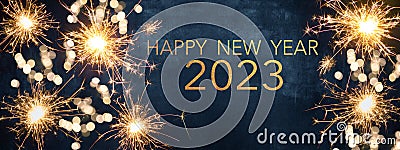 HAPPY NEW YEAR 2023 Party background greeting card - Sparklers and bokeh lights, on dark blue night sky Stock Photo