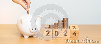Happy New Year with piggy bank and flipping 2023 change to 2024 block. Resolution, Goals, Plan, Action, Money Saving, Retirement Stock Photo