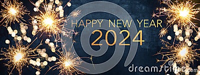 HAPPY NEW YEAR 2024 / New Year`s Eve Party background greeting card - Sparklers and bokeh lights, on dark blue night sky Stock Photo