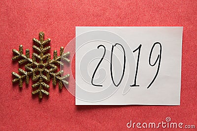 2019 Happy New Year card with text and golden glitter snowflake on pink background Stock Photo