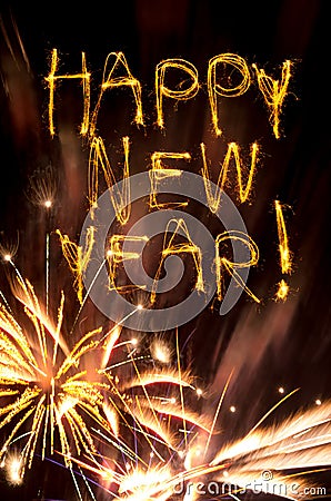 Happy New Year sparklers with gold fireworks Stock Photo