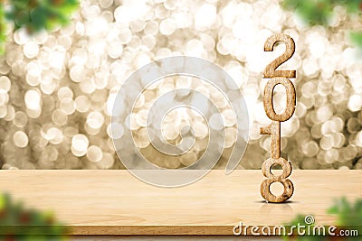 Happy new year 2018 on wood table and blur Christmas tree foreground at blur sparkling gold bokeh light wall,panoramic banner for Stock Photo