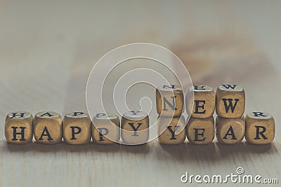 Happy New Year - words from letters on wooden cubes Stock Photo