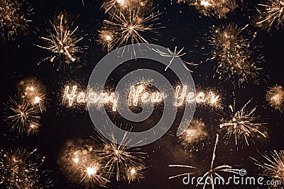 Happy New Year written with sparkle fireworks on night sky Stock Photo