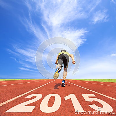 Happy new year 2015. young man running on track Stock Photo