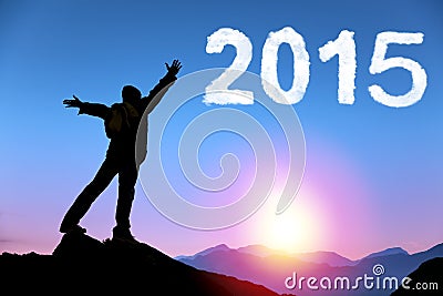 Happy new year 2015. young man standing on the top of mountain Stock Photo