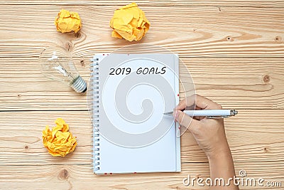 2019 Happy New years with Businessman writing with lightbulb and crumbled paper on table. New Start, Idea, Creative, Innovation, Stock Photo