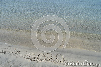 Happy New Years 2020 handwritten on sand Stock Photo