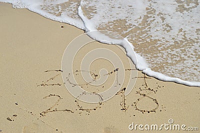 Happy New Years 2018 handwritten on sand Stock Photo