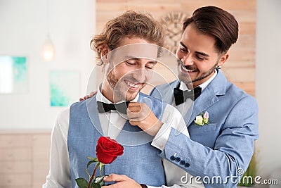 Happy newlywed gay couple with flower Stock Photo