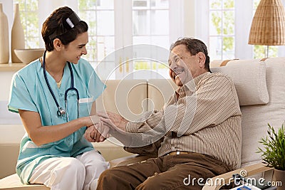 Happy nurse and elderly patient. Stock Photo