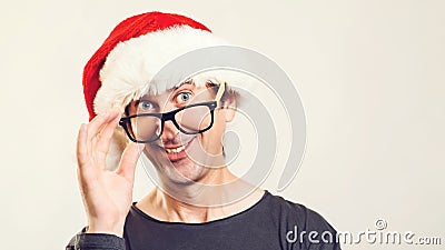 Happy office worker in Santa hat over white background, copy space. Happy Christmas holidays. New Year celebration. Christmas Stock Photo