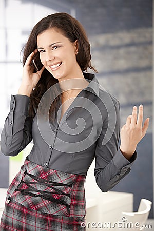 Happy office worker using mobile smiling Stock Photo