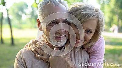 Happy old couple hugging, resting in park together, grandparents closeness Stock Photo