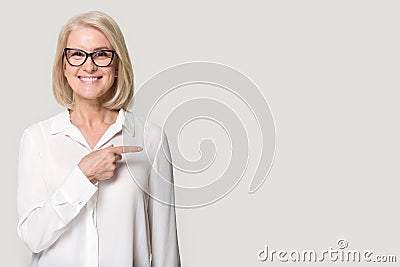 Happy old woman in glasses showing to copyspace blank space Stock Photo