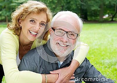 Happy older couple smiling and showing affection Stock Photo