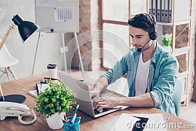 Happy operator of call center in headphones speaking to the client Stock Photo