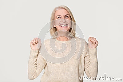 Happy overjoyed middle aged woman celebrating win isolated on background Stock Photo