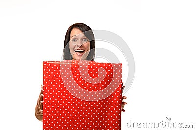 Happy overjoyed woman holding a large red gift Stock Photo