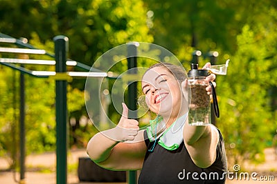 Happy oversized woman with bottle of water smiles Stock Photo