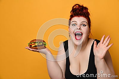 Happy overweight fat woman happy hold big burger cheeseburger sandwich. Girl on diet dieting. Healthy eating fast food concept Stock Photo