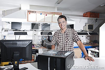 Happy owner of a computer repair store Stock Photo