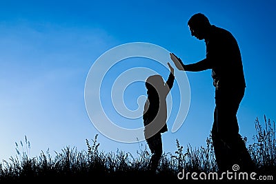 Happy parent with child in the park outdoors silhouette Stock Photo