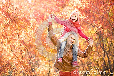 Happy parent and kid walking together outdoor in autumn park Stock Photo