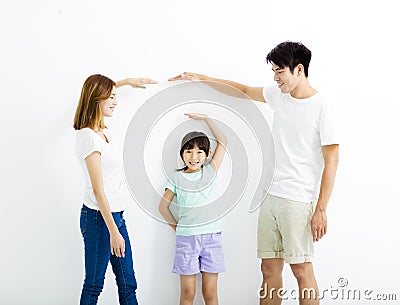 Happy parent measures the growth of daughter Stock Photo