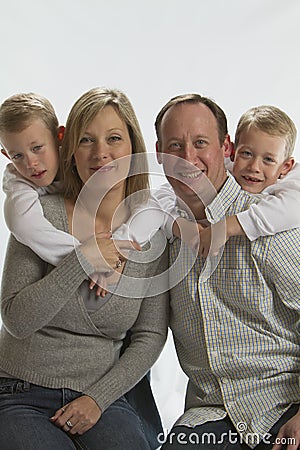 Happy parents with 6 years old identical twins Stock Photo