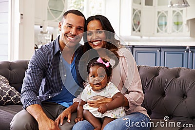 Happy parents with a baby girl sitting on mumï¿½s knee Stock Photo