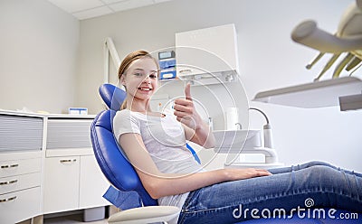 Happy patient girl showing thumbs up at clinic Stock Photo