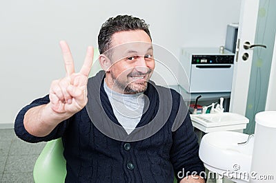 Happy patient sitting trustful on dentist chair Stock Photo