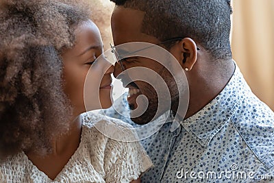 Happy peaceful african american family enjoying tender lovely moment. Stock Photo