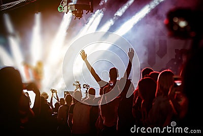 Happy people enjoying rock concert, raised up hands and clapping of pleasure Editorial Stock Photo