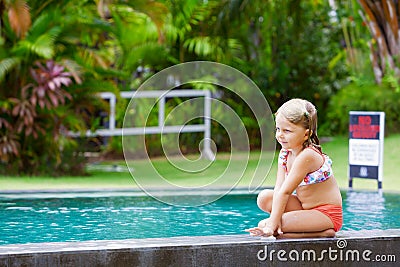 Funny photo of little child relaxing in outdoor swimming pool Stock Photo