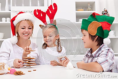 Happy people making gingerbread christmas tree Stock Photo