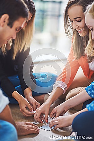 Happy, people and puzzle for teamwork, support and problem solving of challenge, synergy and cooperation. Group, team Stock Photo