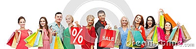 Happy people with sale sign on shopping bags Stock Photo