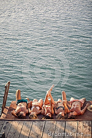People spend leisure time together at vacation at dock Stock Photo